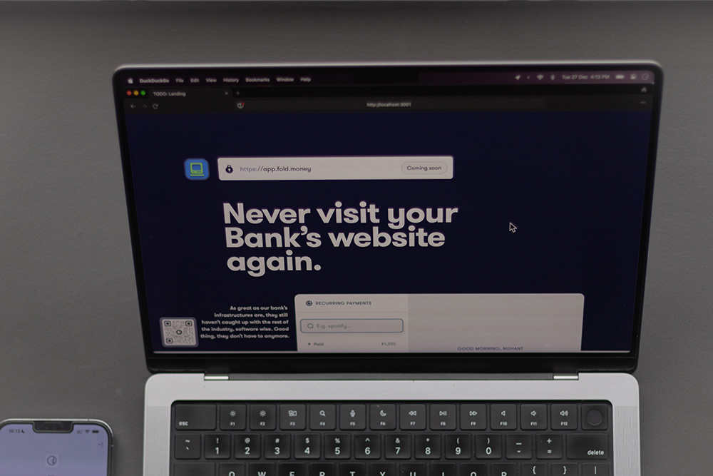 laptop on the desk with fold web app website open in the browser. visible text on the site reads - never visit your bank's website again